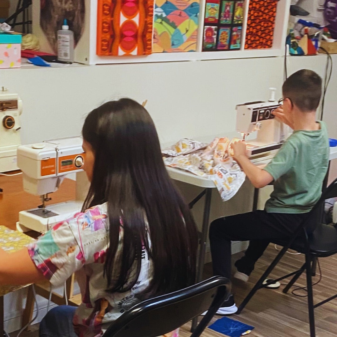 Girl and a boy using sewing machines