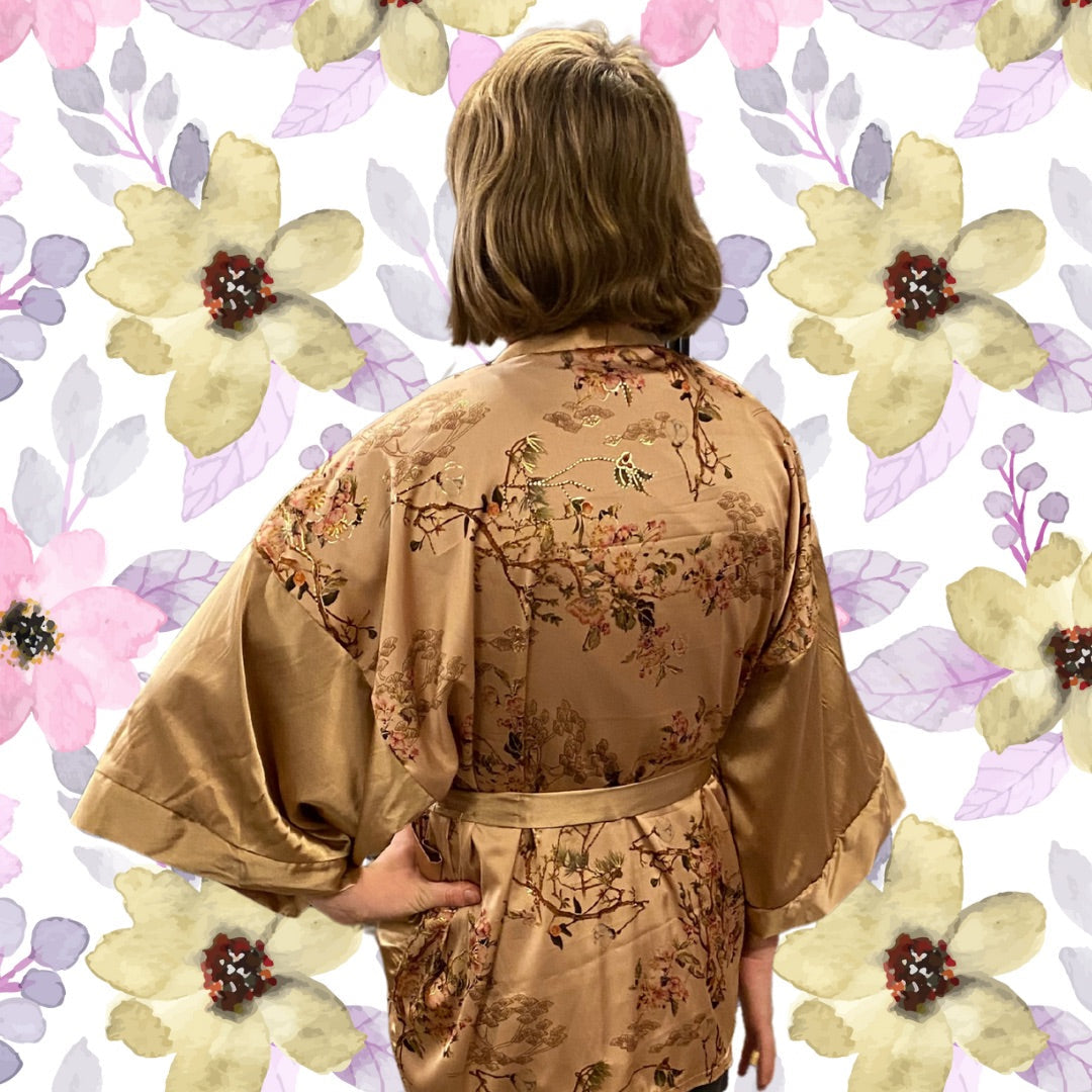 Person wearing a floral kimono against a floral patterned background